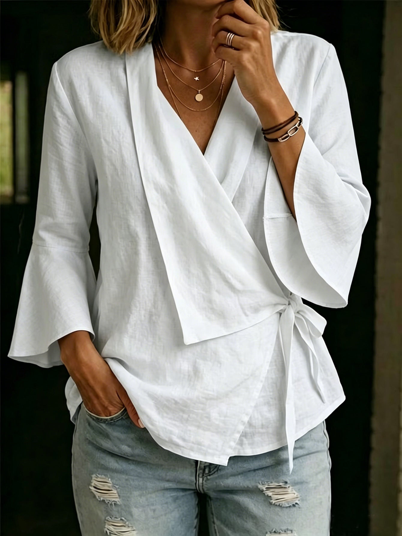 Asymmetric women's blouse with lapels and flared sleeves