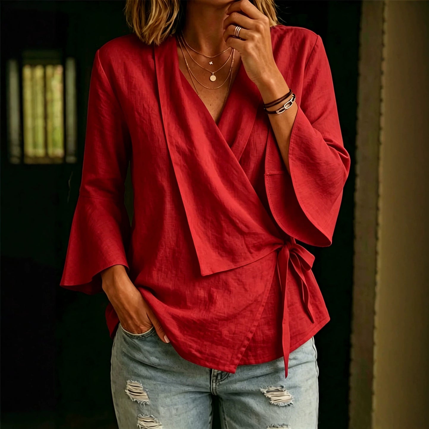 Asymmetric women's blouse with lapels and flared sleeves