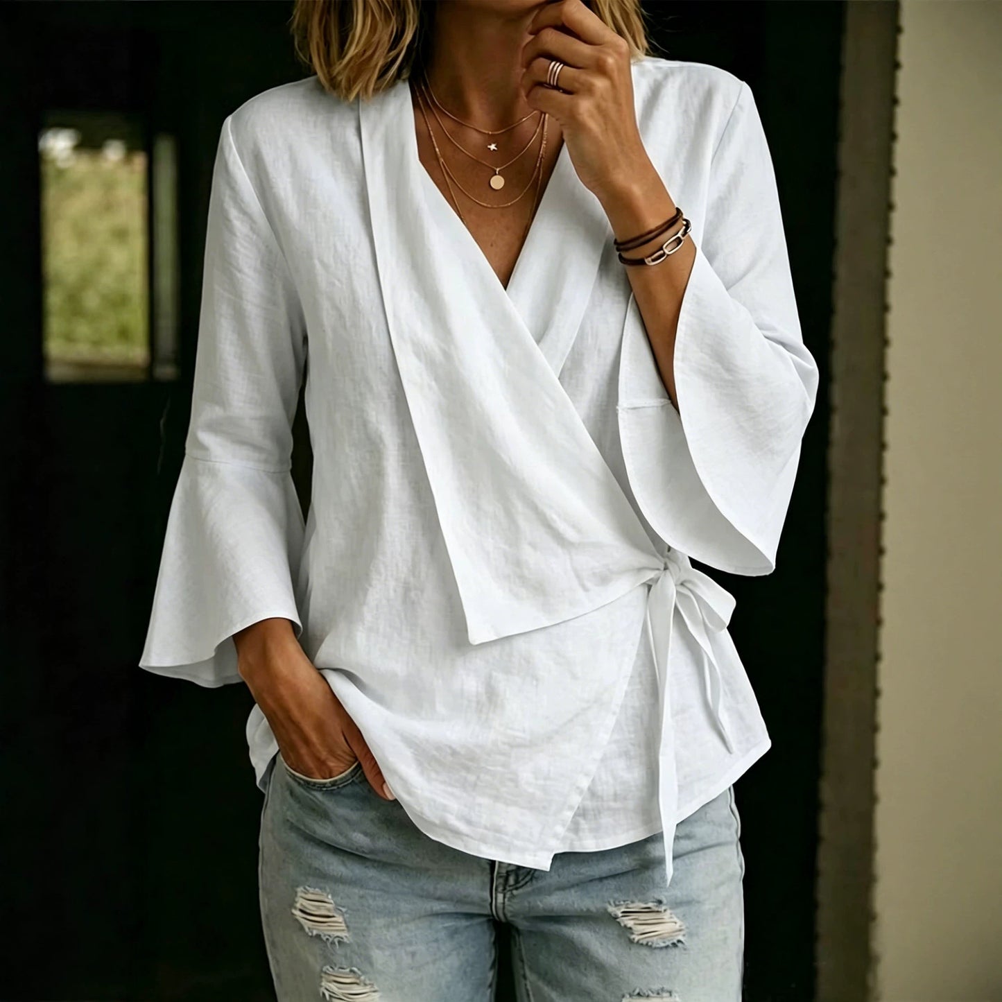 Asymmetric women's blouse with lapels and flared sleeves