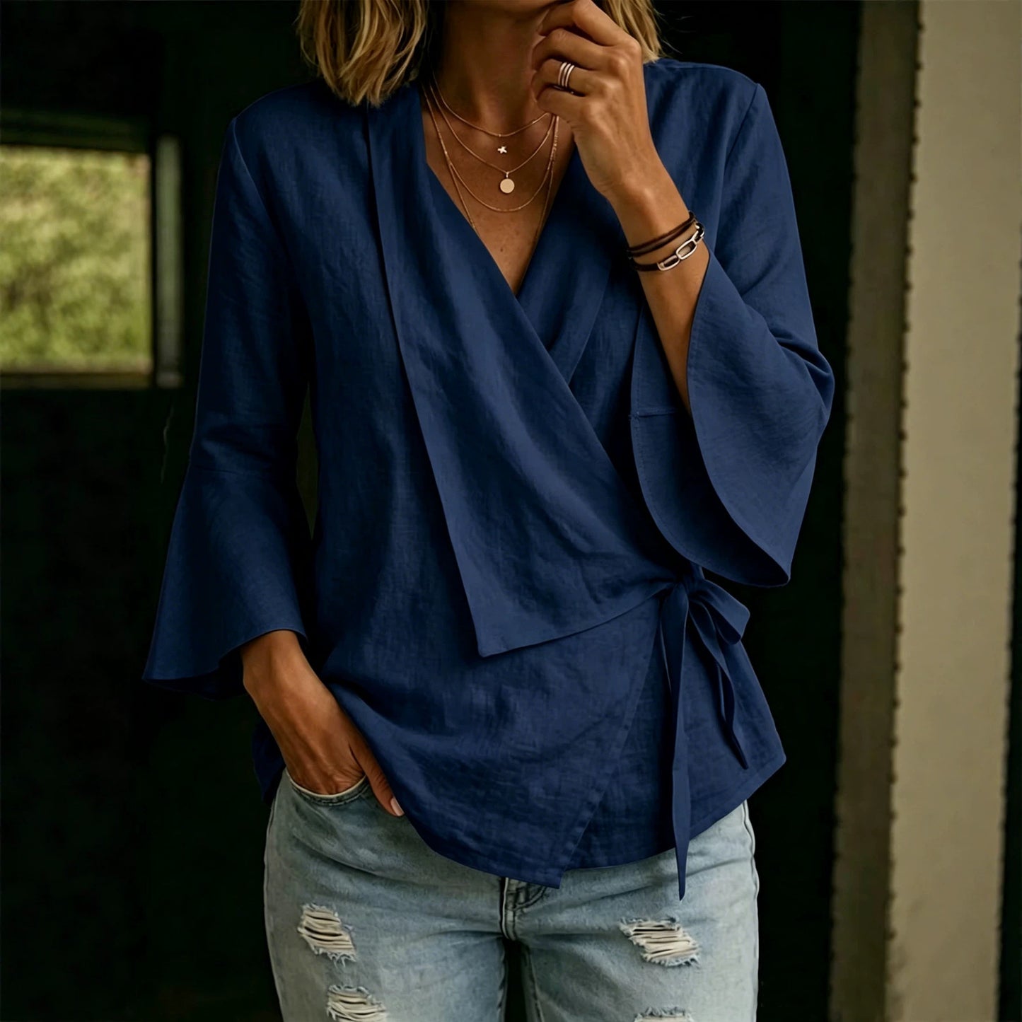 Asymmetric women's blouse with lapels and flared sleeves