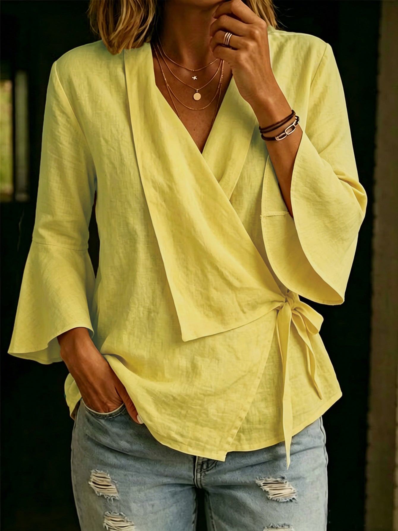 Asymmetric women's blouse with lapels and flared sleeves